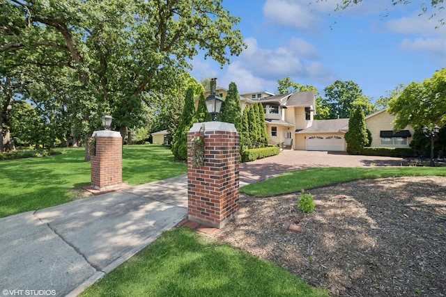 691 Lake Ave, Crystal Lake, IL 60014 - view of front facade featuring a front yard, driveway, a garage, and a chimney