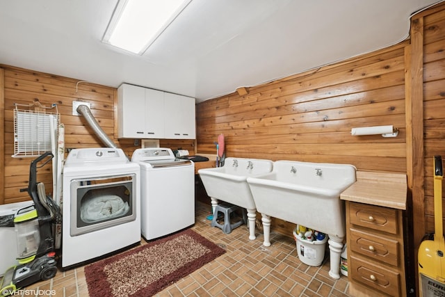 691 Lake Ave, Crystal Lake, IL 60014 - washroom featuring independent washer and dryer, wood walls, cabinet space, and brick patterned flooring