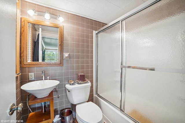 691 Lake Ave, Crystal Lake, IL 60014 - bathroom with tile walls, shower / bath combination with glass door, and vanity