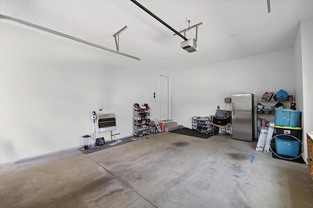 1311 Hickory Tree Ct, Mahomet, IL 61853 - garage featuring freestanding refrigerator, a garage door opener, and heating unit