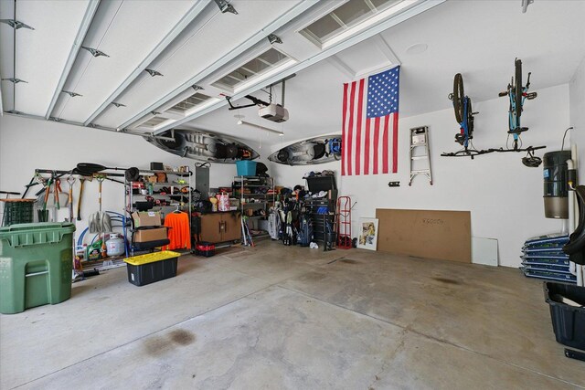 1311 Hickory Tree Ct, Mahomet, IL 61853 - garage with a garage door opener and a central vacuum unit