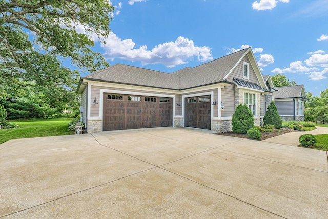 1311 Hickory Tree Ct, Mahomet, IL 61853 - view of home's exterior with stone siding, concrete driveway, an attached garage, and a shingled roof