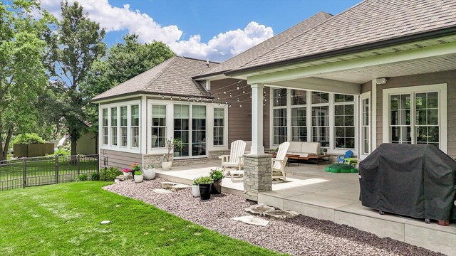 1311 Hickory Tree Ct, Mahomet, IL 61853 - back of property featuring a patio area, a shingled roof, and stone siding