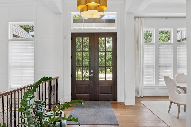 1311 Hickory Tree Ct, Mahomet, IL 61853 - entrance foyer with french doors, a chandelier, and wood finished floors