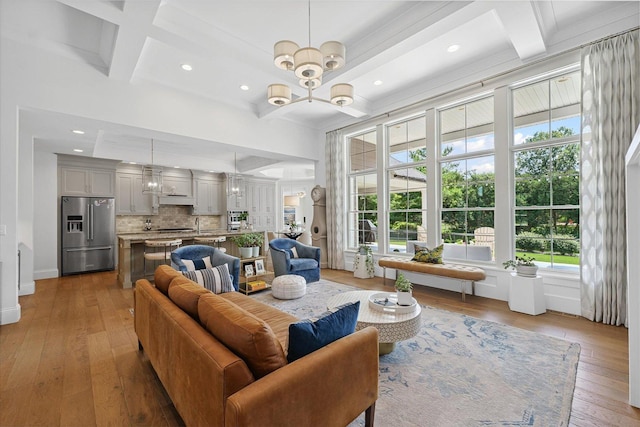 1311 Hickory Tree Ct, Mahomet, IL 61853 - living area with coffered ceiling, light wood-type flooring, recessed lighting, beamed ceiling, and a chandelier
