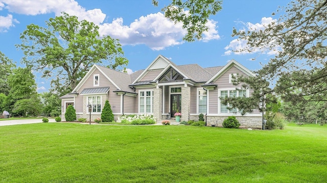 1311 Hickory Tree Ct, Mahomet, IL 61853 - craftsman-style house with stone siding, a front yard, a standing seam roof, and a metal roof