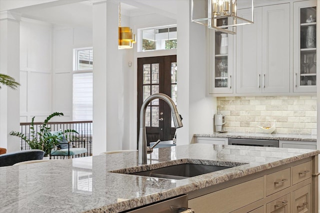 1311 Hickory Tree Ct, Mahomet, IL 61853 - kitchen with a chandelier, light stone countertops, and glass insert cabinets