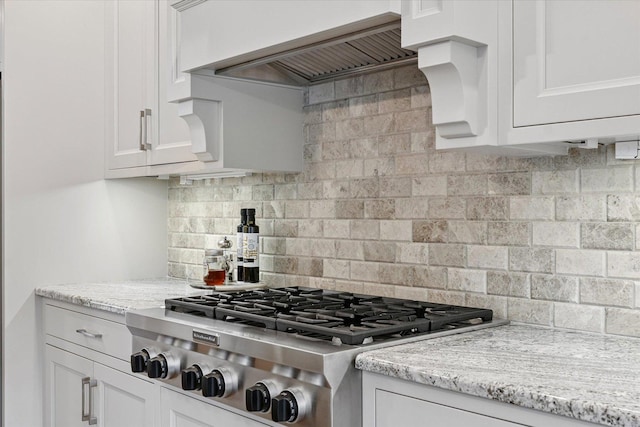 1311 Hickory Tree Ct, Mahomet, IL 61853 - kitchen featuring stainless steel gas cooktop, custom range hood, tasteful backsplash, and white cabinetry