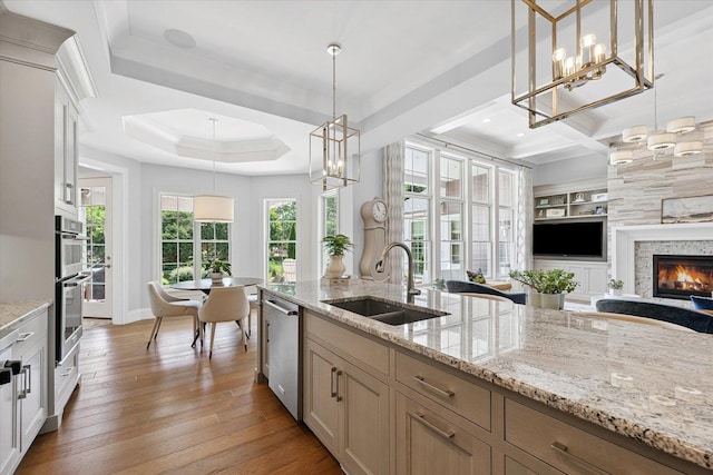 1311 Hickory Tree Ct, Mahomet, IL 61853 - kitchen featuring appliances with stainless steel finishes, light wood finished floors, open floor plan, and healthy amount of natural light