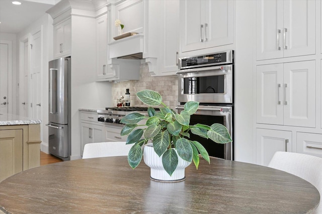1311 Hickory Tree Ct, Mahomet, IL 61853 - kitchen featuring appliances with stainless steel finishes, recessed lighting, backsplash, and white cabinets