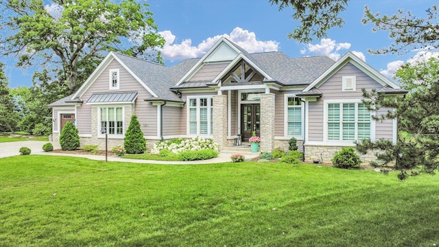 1311 Hickory Tree Ct, Mahomet, IL 61853 - craftsman-style house featuring stone siding, a front lawn, and a standing seam roof
