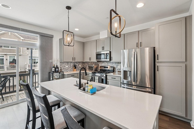 30W003 Brayman Ct, Warrenville, IL 60563 - kitchen featuring stainless steel appliances, gray cabinetry, backsplash, a breakfast bar, and recessed lighting