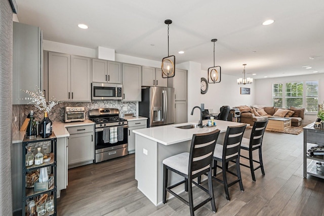 30W003 Brayman Ct, Warrenville, IL 60563 - kitchen with stainless steel appliances, gray cabinetry, tasteful backsplash, dark wood-style flooring, and recessed lighting