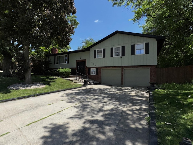 400 N Cottage Ave, Normal, IL 61761 - bi-level home with an attached garage, concrete driveway, and brick siding
