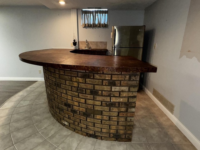 400 N Cottage Ave, Normal, IL 61761 - indoor wet bar with freestanding refrigerator and tile patterned floors