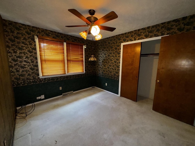 400 N Cottage Ave, Normal, IL 61761 - unfurnished bedroom with carpet floors, a closet, a ceiling fan, and wallpapered walls