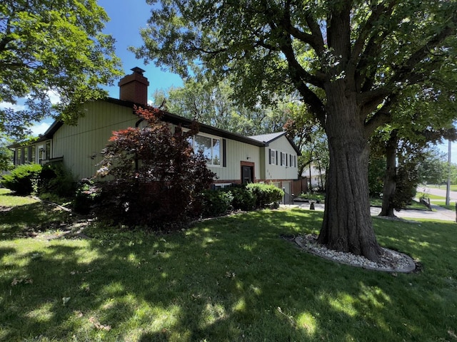 400 N Cottage Ave, Normal, IL 61761 - view of home's exterior featuring a chimney and a lawn