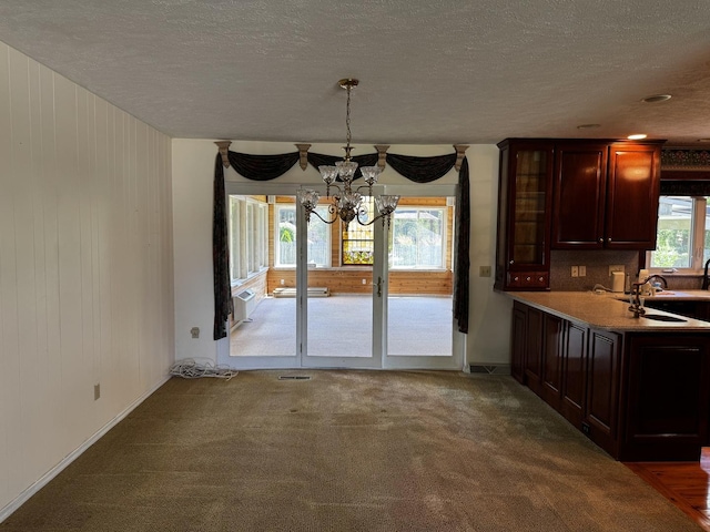 400 N Cottage Ave, Normal, IL 61761 - unfurnished dining area with a chandelier, a textured ceiling, and carpet floors