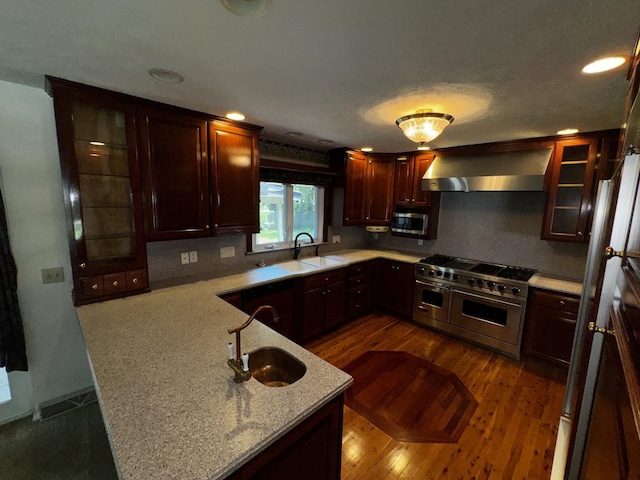 400 N Cottage Ave, Normal, IL 61761 - kitchen featuring wall chimney exhaust hood, appliances with stainless steel finishes, a peninsula, backsplash, and recessed lighting