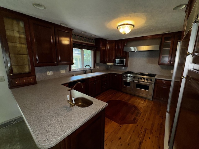 400 N Cottage Ave, Normal, IL 61761 - kitchen featuring appliances with stainless steel finishes, extractor fan, a peninsula, light countertops, and dark wood-style flooring