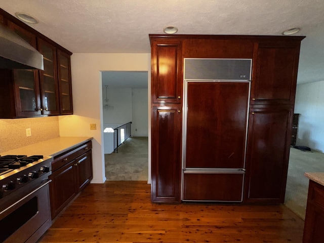 400 N Cottage Ave, Normal, IL 61761 - kitchen featuring wall chimney exhaust hood, paneled built in refrigerator, stainless steel range with gas cooktop, dark wood finished floors, and light countertops