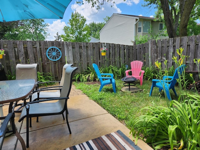 543 Norman Rd Unit 543, Bolingbrook, IL 60440 - fenced backyard with outdoor dining area, a fire pit, and a patio area