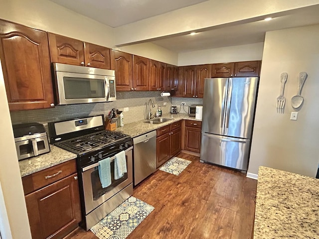 543 Norman Rd Unit 543, Bolingbrook, IL 60440 - kitchen featuring stainless steel appliances, decorative backsplash, dark wood-style flooring, and light stone counters
