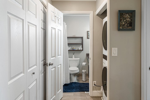1811 Four Lakes Ave Unit 1H, Lisle, IL 60532 - bathroom featuring stacked washer / drying machine and wood finished floors