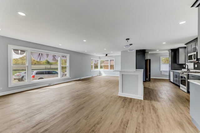 14911 Woodlawn Ave, Dolton, IL 60419 - kitchen featuring stainless steel appliances, light wood-style floors, recessed lighting, open floor plan, and a kitchen island