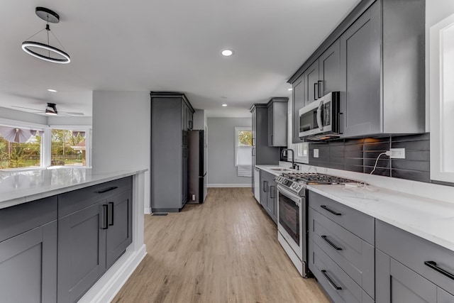 14911 Woodlawn Ave, Dolton, IL 60419 - kitchen featuring stainless steel appliances, gray cabinets, decorative backsplash, light stone countertops, and recessed lighting