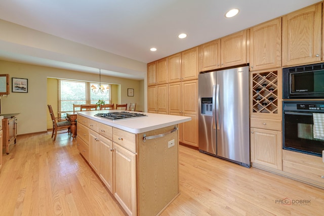 24 Hickory Rd, Oakwood Hills, IL 60013 - kitchen with black appliances, light brown cabinets, light wood finished floors, a center island, and light countertops