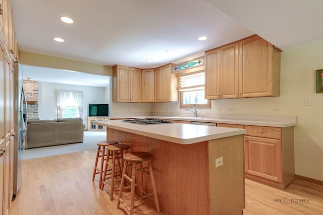 24 Hickory Rd, Oakwood Hills, IL 60013 - kitchen with light brown cabinetry, a breakfast bar area, light wood-style floors, stainless steel appliances, and recessed lighting