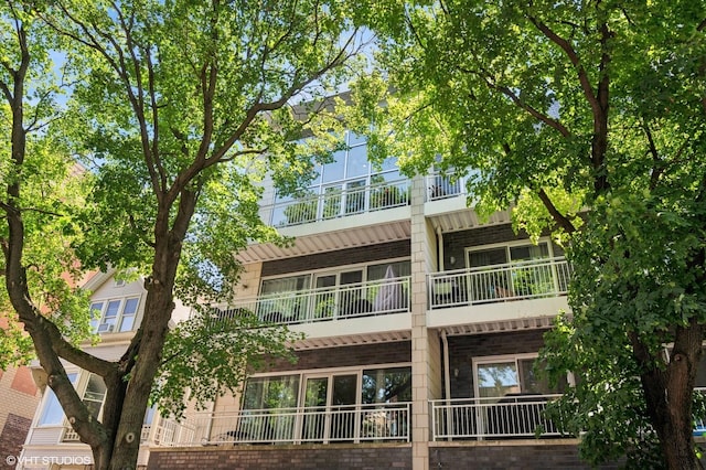 3255 N Paulina St Unit 4A, Chicago, IL 60657 - back of house featuring a balcony and brick siding