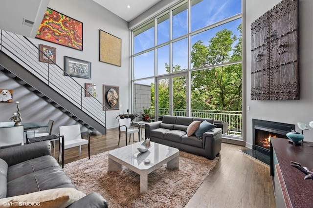3255 N Paulina St Unit 4A, Chicago, IL 60657 - living area featuring healthy amount of natural light, a fireplace with flush hearth, wood finished floors, and expansive windows