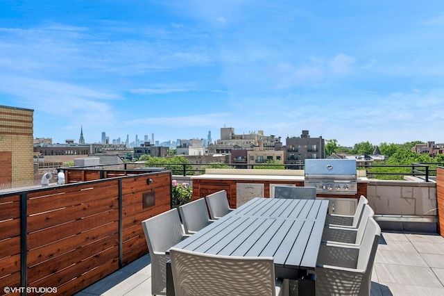 3255 N Paulina St Unit 4A, Chicago, IL 60657 - view of patio with a skyline view, an outdoor kitchen, and outdoor dining space