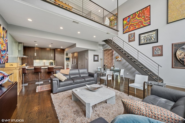 3255 N Paulina St Unit 4A, Chicago, IL 60657 - living room with dark wood-style flooring, stairway, a towering ceiling, recessed lighting, and bar area