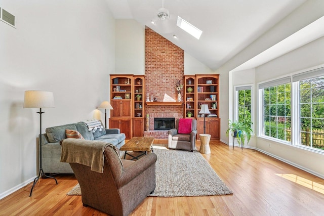 2524 Wild Timothy Rd, Naperville, IL 60564 - living area with high vaulted ceiling, a fireplace, a skylight, plenty of natural light, and wood finished floors