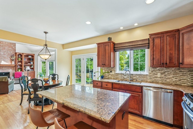2524 Wild Timothy Rd, Naperville, IL 60564 - kitchen featuring appliances with stainless steel finishes, a breakfast bar area, light wood-style flooring, backsplash, and recessed lighting