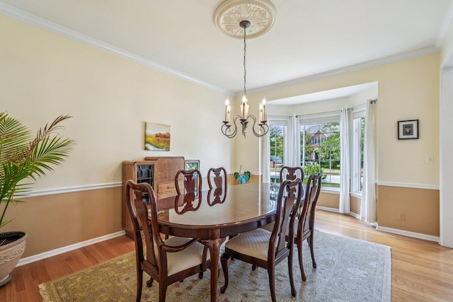 2524 Wild Timothy Rd, Naperville, IL 60564 - dining area with light wood finished floors, crown molding, and a chandelier
