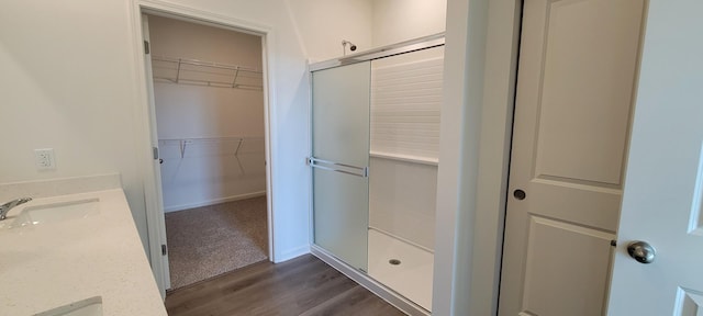 6473 Juniper Dr, Wonder Lake, IL 60097 - full bathroom with a shower stall, vanity, wood finished floors, and a spacious closet