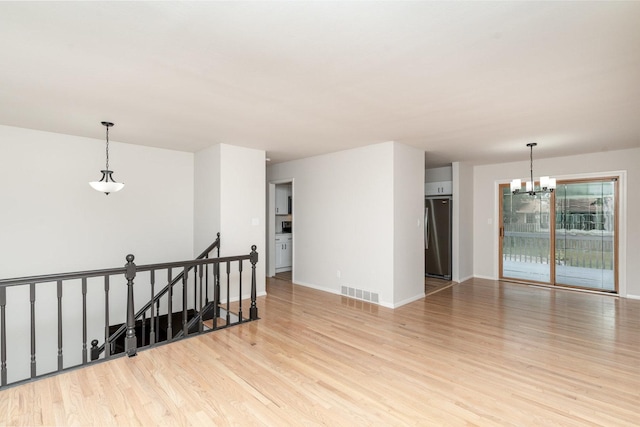 1121 S 13th St, Saint Charles, IL 60174 - unfurnished room featuring a chandelier and light wood-style floors