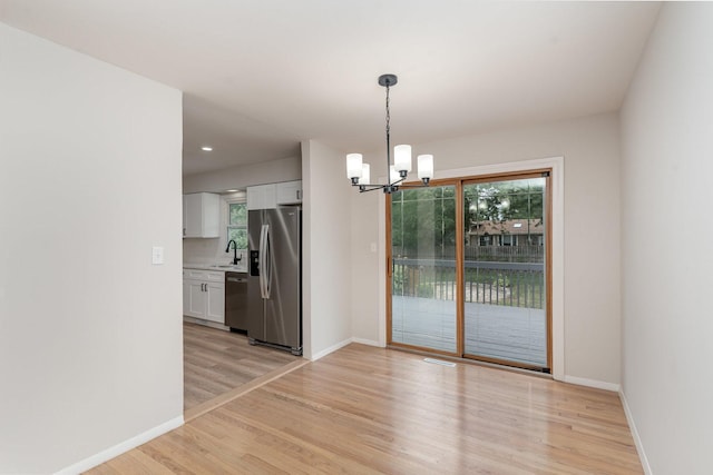 1121 S 13th St, Saint Charles, IL 60174 - unfurnished dining area with a chandelier and light wood-type flooring