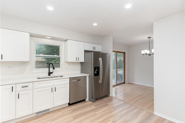 1121 S 13th St, Saint Charles, IL 60174 - kitchen with appliances with stainless steel finishes, decorative backsplash, light wood finished floors, white cabinetry, and recessed lighting