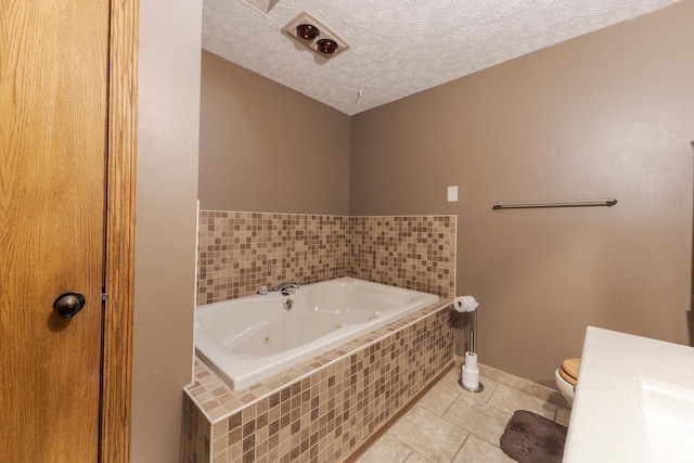 1413 Bethany Ln, Pontiac, IL 61764 - bathroom featuring a jetted tub, tile patterned floors, a textured ceiling, and vanity