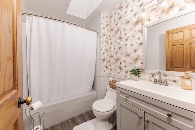1413 Bethany Ln, Pontiac, IL 61764 - bathroom featuring a skylight, wallpapered walls, a wainscoted wall, vanity, and wood finished floors