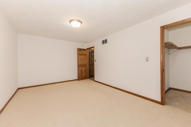 1413 Bethany Ln, Pontiac, IL 61764 - unfurnished bedroom featuring light colored carpet, a spacious closet, and a closet