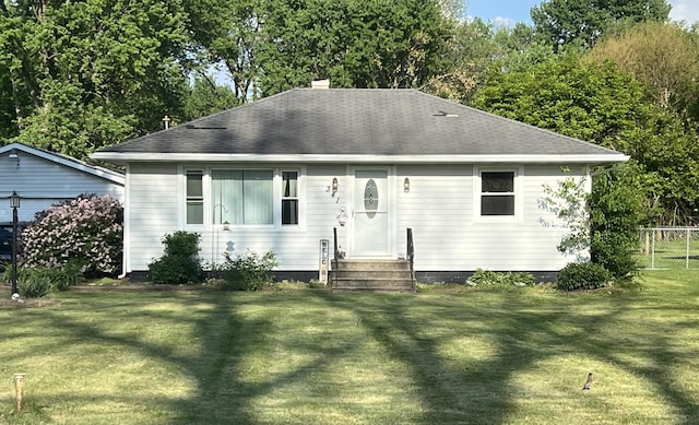 341 N Center St, Braidwood, IL 60408 - view of front facade with a shingled roof, a chimney, a front yard, and entry steps