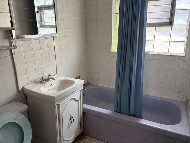 5535 S Fairfield Ave, Chicago, IL 60629 - full bathroom with tile walls, vanity, and shower / tub combo with curtain