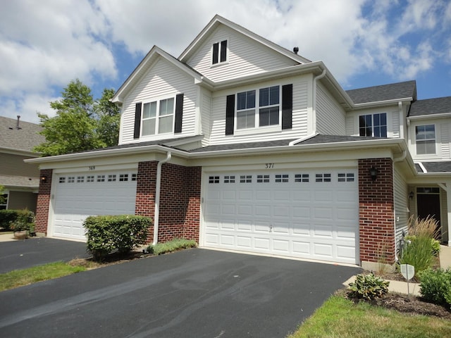 371 Mcgrath Dr, Oswego, IL 60543 - traditional-style house with asphalt driveway, a garage, and brick siding