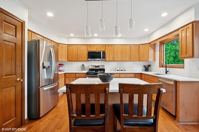 1167 Book Rd, Naperville, IL 60540 - kitchen with appliances with stainless steel finishes, light wood-type flooring, a center island, light countertops, and recessed lighting